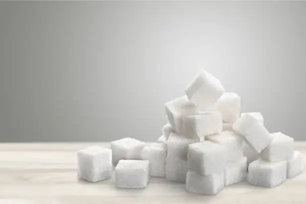 Cubes of sugar on white background