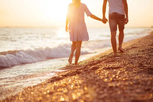 Photo of Young happy couple on seashore.