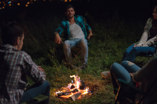 istock The young people sit near the bonfire. evening night time 1024652862