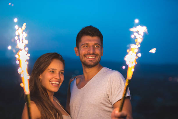 istock The happy couple hold a firework sticks. evening night time 1024653516