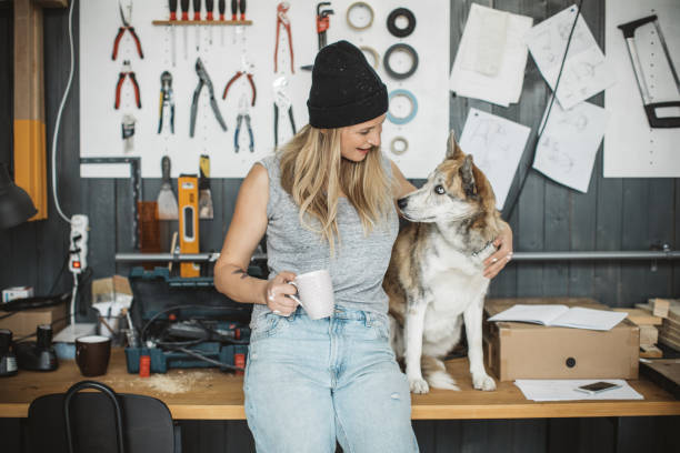 istock Women in workshop with her pet dog 1024657374