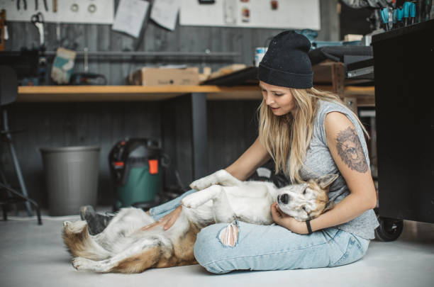 istock Women in workshop with her pet dog 1024657418