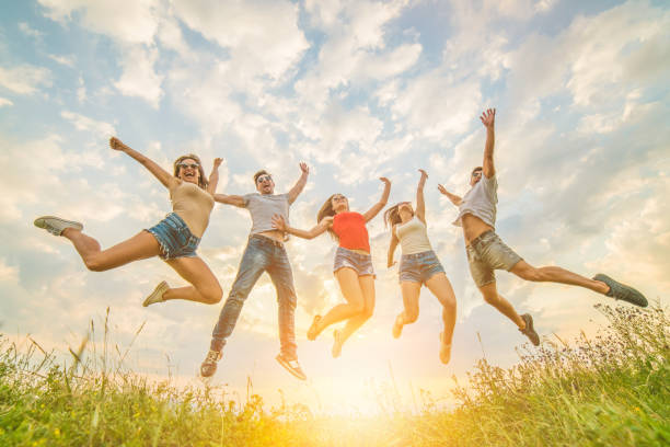 istock The five friends jumping on the grass on the sunny background 1024666254