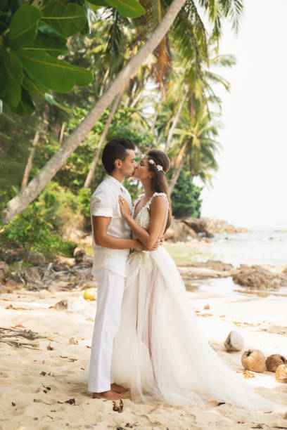 istock Young and beautiful couple is celebrating wedding on the beach 1024667308