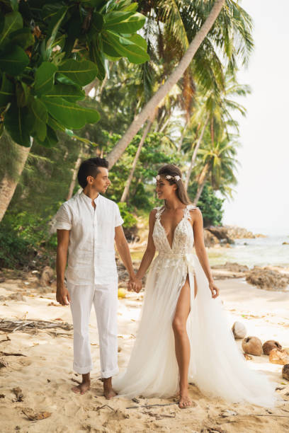 istock Young and beautiful couple is celebrating wedding on the beach 1024667314