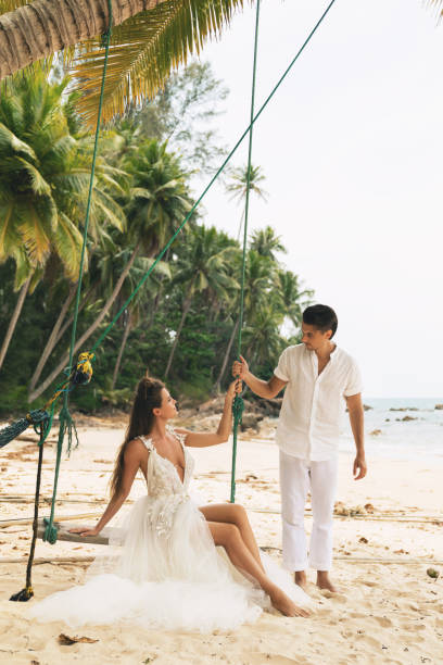 istock Happy young married couple celebrating their wedding on the beach 1024667444