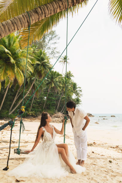 istock Happy young married couple celebrating their wedding on the beach 1024667526