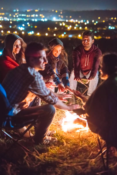 istock The happy people warming hands near the bonfire. evening night time 1024667544