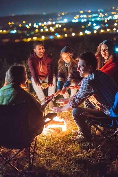 istock The happy people warming hands near the bonfire. evening night time 1024667566