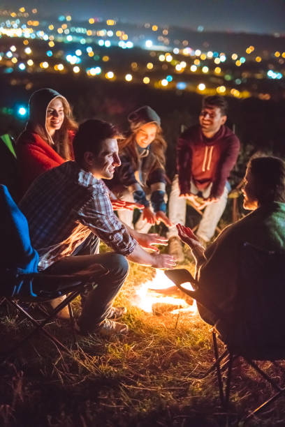 istock The happy people warming hands near the bonfire. evening night time 1024667698