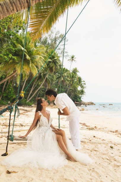 istock Happy young married couple celebrating their wedding on the beach 1024667702