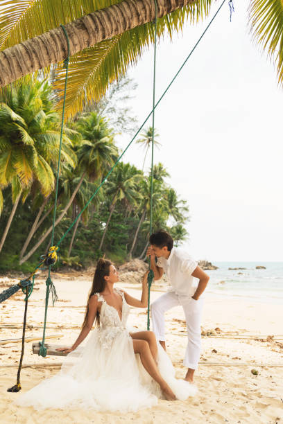 istock Happy young married couple celebrating their wedding on the beach 1024667708