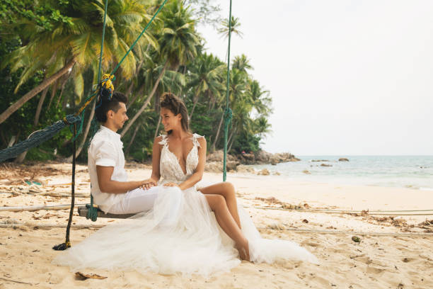 istock Happy young married couple celebrating their wedding on the beach 1024669832