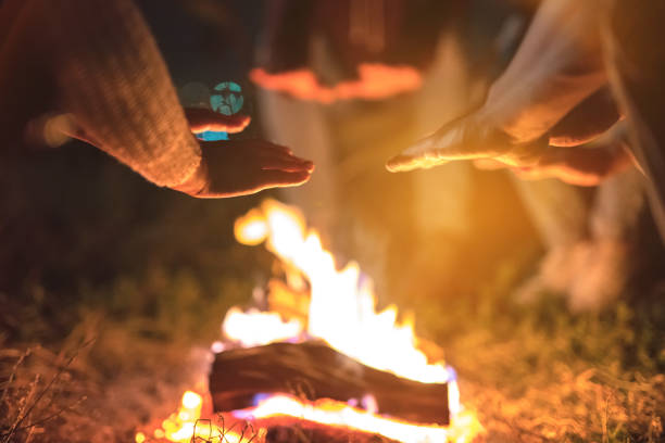 istock The people warming hands near a bonfire. evening night time 1024669836