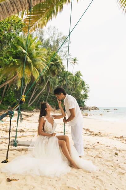 istock Happy young married couple celebrating their wedding on the beach 1024669848