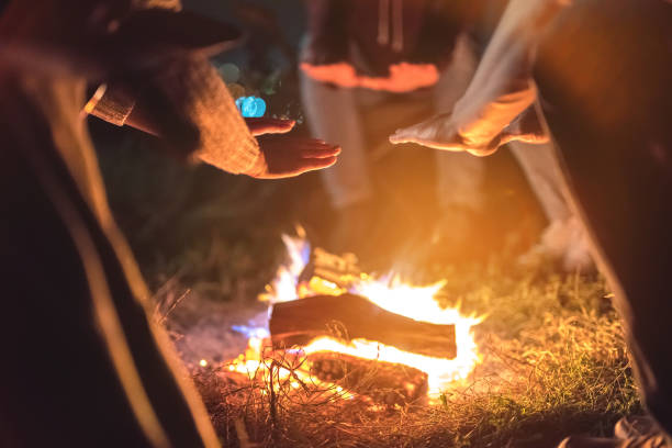 istock The people warming hands near a bonfire. evening night time 1024669950