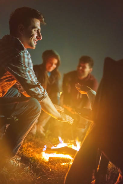 istock The people warming hands above the bonfire. evening night time 1024669970