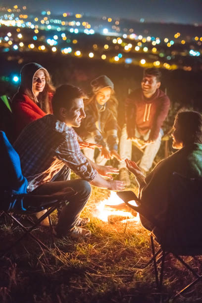 istock The happy people warming hands above the bonfire. evening night time 1024669980