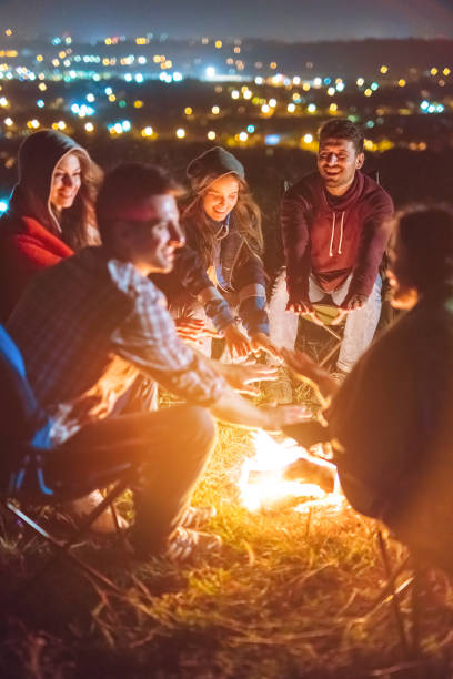 istock The happy people warming hands above the bonfire. evening night time 1024670006