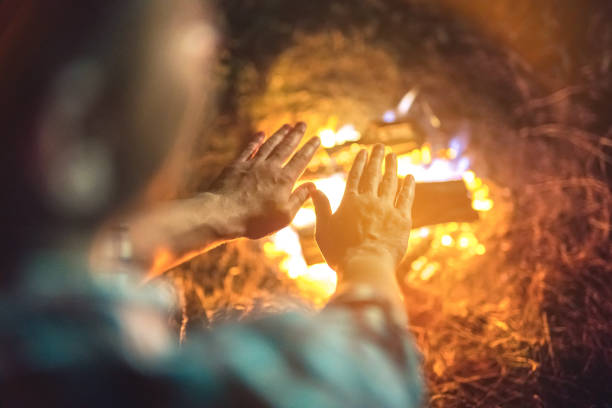 istock The person warming hands above the bonfire. evening night time 1024670032