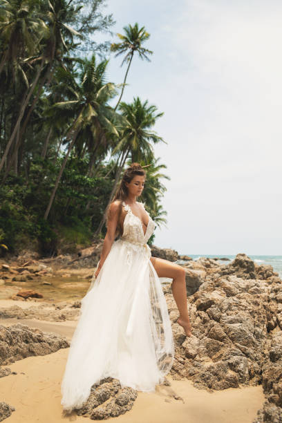 istock Bride wearing beautiful wedding dress on the tropical beach 1024670036