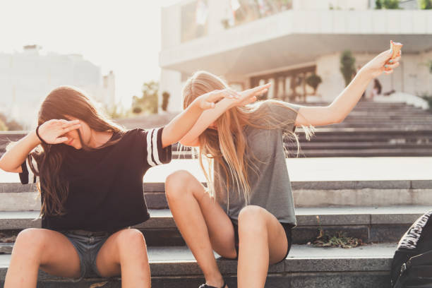 Teenage friends Two teenage girls having fun in the urban part of the city. dab dance stock pictures, royalty-free photos & images