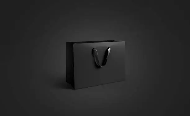 Photo of Blank black paper bag with silk handle mockup, isolated