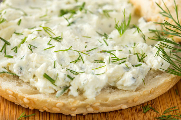 istock Slice of bread or bun with cream cheese with green fresh dill 1024692904