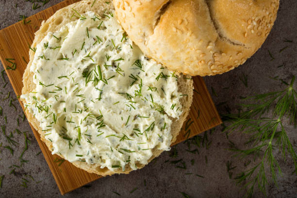 istock Slice of bread or bun with cream cheese with green fresh dill 1024692920