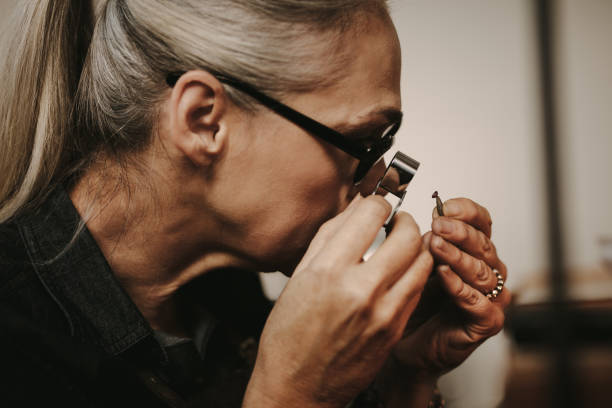 istock Jeweler examining diamond through loupe 1024716064