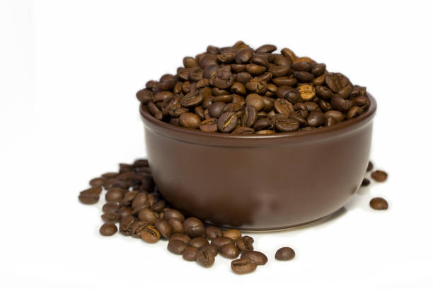 Coffee beans in brown bowl isolated