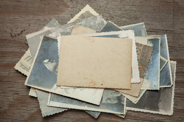 istock Stack old photos on table. Mock-up blank paper. Postcard rumpled and dirty vintage 1024716868
