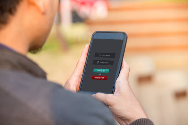 Sign in membership username password concept. Man holding smartphone doing sign in on website at the outdoor.
