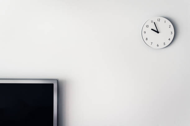 televison and circle clock on white wall. home interior object in house.