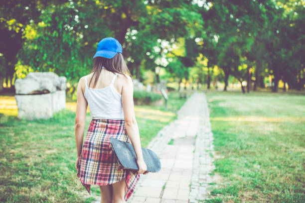 istock Hipster girl walking in a park 1024724274