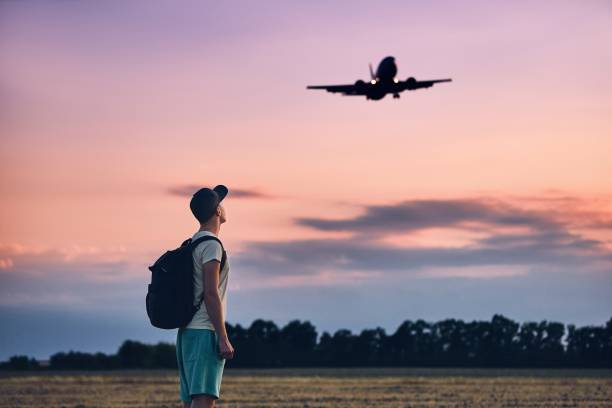 istock Traveler is looking at the landing airplane 1024724898