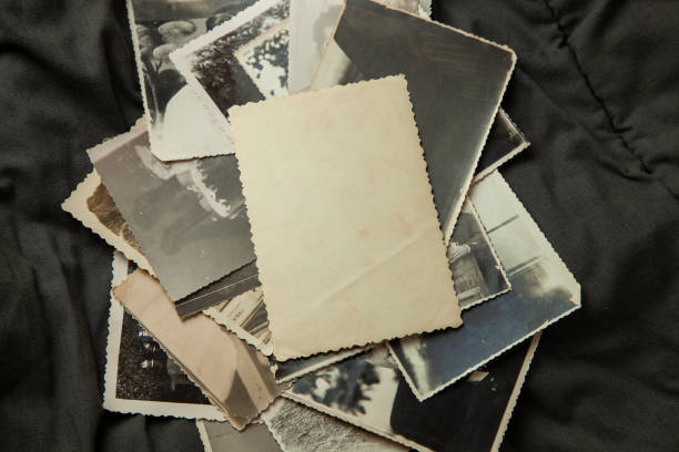 istock Stack old photos on table. Mock-up blank paper. Postcard rumpled and dirty vintage 1024725646