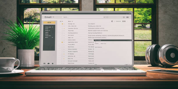 istock Emails on a laptop screen isolated on a wooden desk. 3d illustration 1024733594