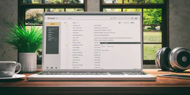Photo of Emails on a laptop screen isolated on a wooden desk. 3d illustration