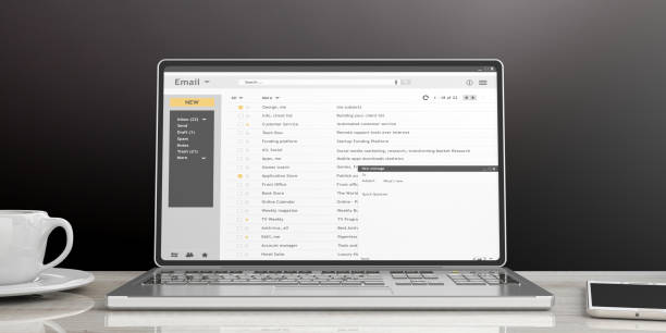 istock Emails on a laptop screen isolated on an office desk, black wall background. 3d illustration 1024733600