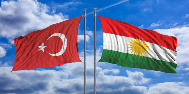 istock Turkey and Kurdistan flags wave opposite under a blue sky with many white clouds. 3d illustration 1024733650