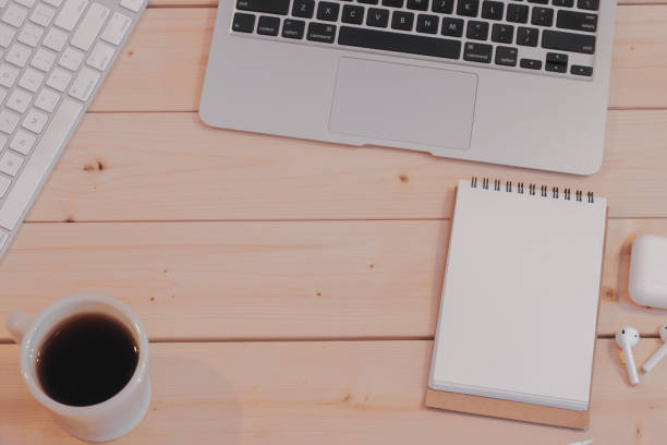 istock Computer, smart phone with notepad, cup of coffee on wooden background 1024734420