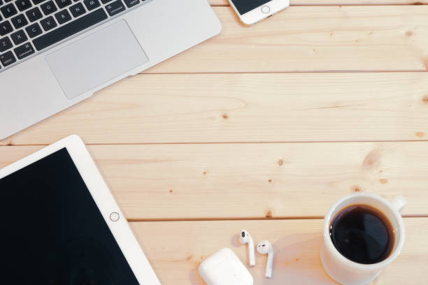 istock Computer, smart phone with notepad, cup of coffee on wooden background 1024734448