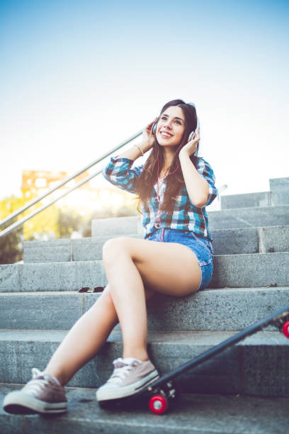 istock Girl in shorts on steps with skateboard 1024735004