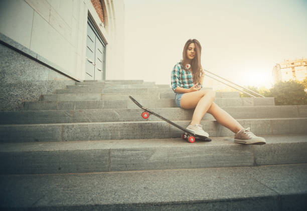 istock Girl in shorts on steps with skateboard 1024735132