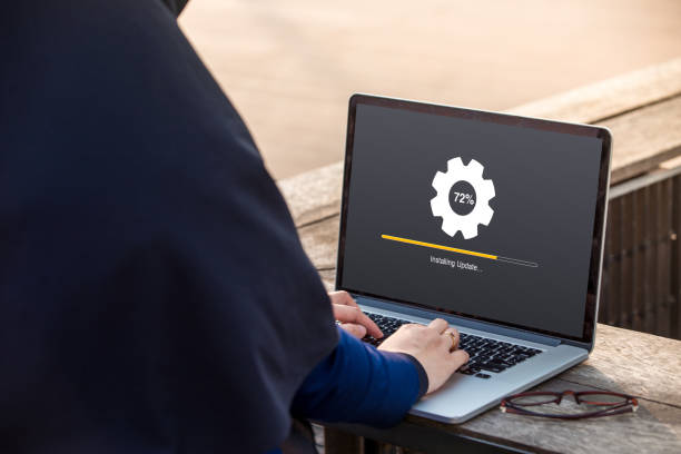 istock Hijab woman is working using laptop doing Installing update process with gearbox percentage at outdoor 1024736862