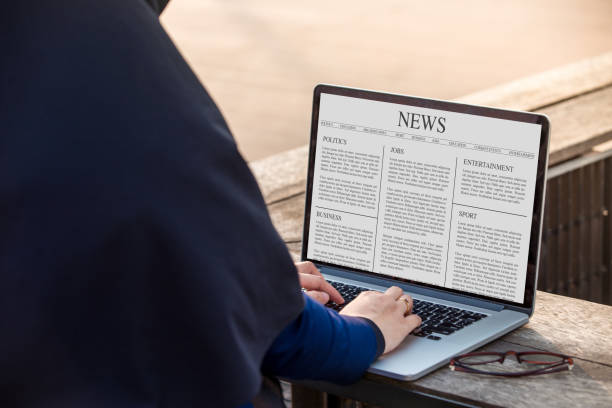 istock Hijab woman is working using laptop reading news article on screen at outdoor 1024737538