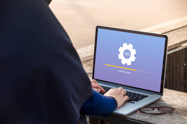 istock Hijab woman is working using laptop doing Installing update process with gearbox percentage at outdoor 1024737580