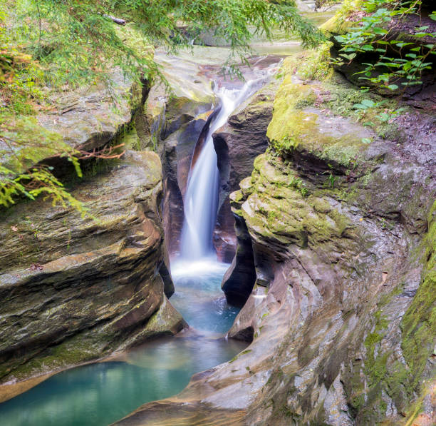 This waterfall, known to visitors as Corkscrew Falls but officially named Robinson Falls by the state, is a little-visited gem hidden off the side of the road in Hocking Hills National Park, near Logan, Ohio.