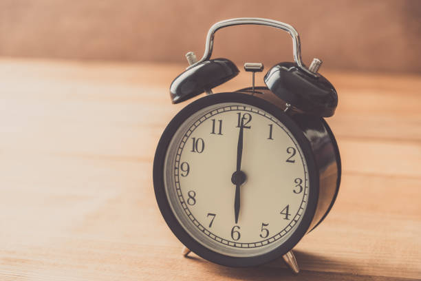 istock Close-Up Of Clock On Wooden Table 1024771188